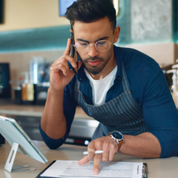 A restaurant employee takes an order over the phone.