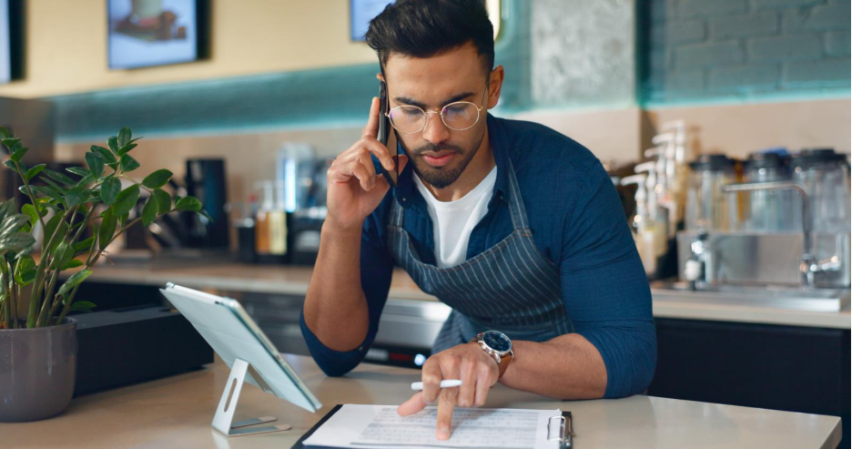 A restaurant employee takes an order over the phone.