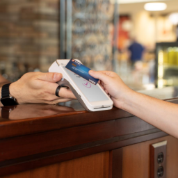 A customer uses their credit card to pay at a restaurant