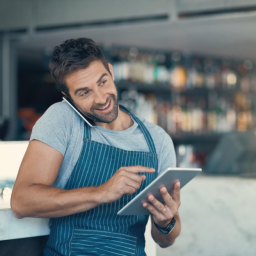 A restaurant employee accepting orders over the phone.