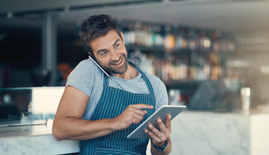 A restaurant employee accepting orders over the phone.
